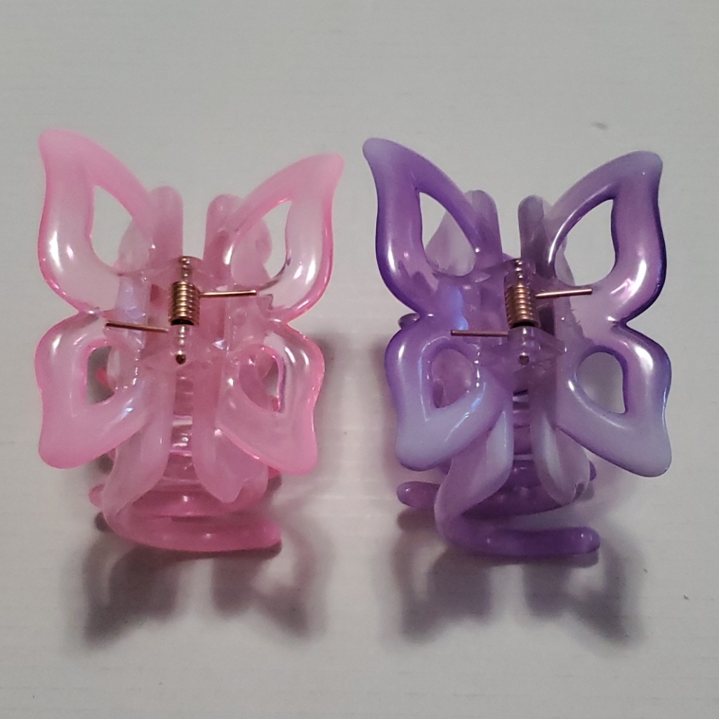 Pink and purple butterfly claw clips showing the hinge and spring mechanism